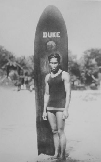 Duke Kahanamoku with surfboard.
